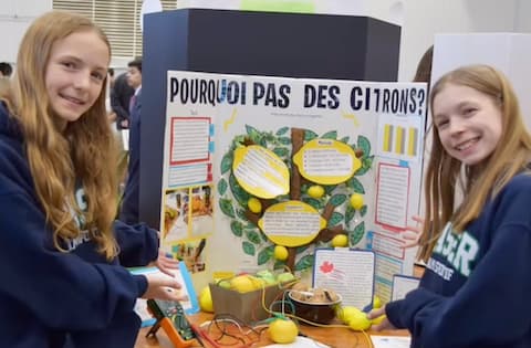 Two students presenting their lemon battery project.