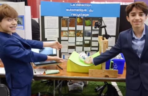 Two boys presenting a project on automated recycling detection.