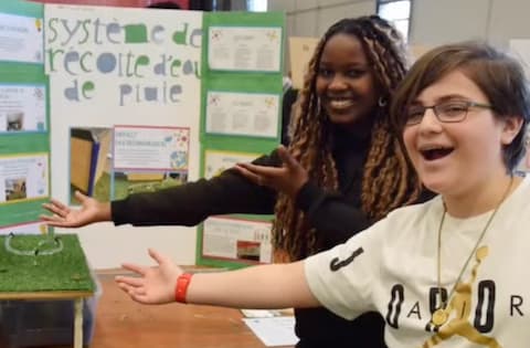 Two students presenting their rainwater harvesting system project.